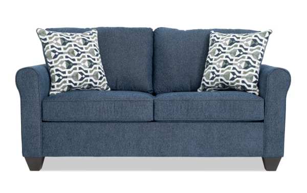 Slumber Navy 72'' Transitional Sleeper Sofa with plush polyester fabric, blue upholstery, patterned accent pillows, and full cooling memory foam mattress.