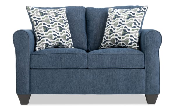Slumber Navy 56'' transitional sleeper sofa with plush navy polyester fabric, Bob-O-Pedic cooling gel memory foam mattress, and patterned accent pillows.