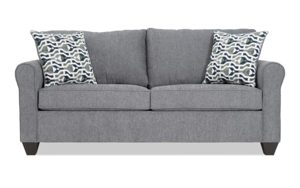 Slumber Gray 80'' transitional sleeper sofa with plush gray polyester fabric, patterned accent pillows, and a queen gel memory foam mattress for guest comfort.