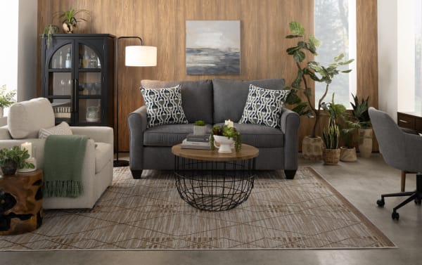 Transitional Slumber Gray 56'' Sleeper Sofa in gray polyester fabric with accent pillows, plush cushions, and pull-out twin gel memory foam mattress.