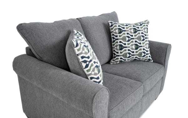 Slumber Gray 56'' transitional sleeper sofa with plush gray polyester fabric, two patterned accent pillows, and a twin gel memory foam mattress.