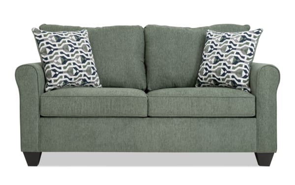 Slumber Green 72'' transitional sleeper sofa with plush green polyester fabric, two patterned accent pillows, and full gel memory foam mattress.
