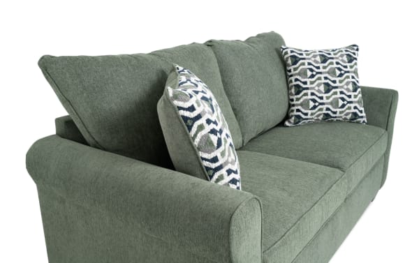 Slumber Green 72'' transitional sleeper sofa in green polyester fabric with plush cushions, patterned accent pillows, and full gel memory foam mattress.