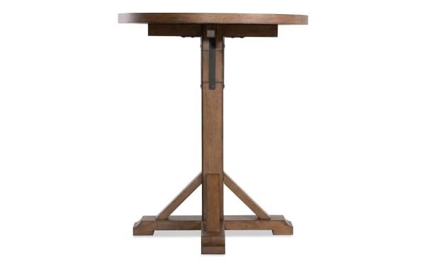 Iris Brown Adjustable Height Round Dining Table with a warm brown oak veneer finish, transitional style, and sturdy pedestal base from the Iris Dining collection.