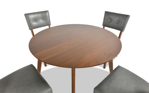 Mid-century modern Bettie 5 Piece Walnut & Charcoal Faux Leather Upholstered Round Dining Set with flared wood legs, gray faux leather seats, and walnut MDF tabletop.