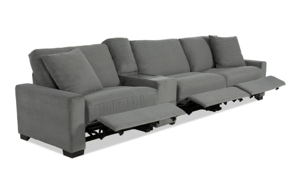Gray fabric reclining sectional sofa with three seats and padded cushions, featuring extended footrests for enhanced comfort.