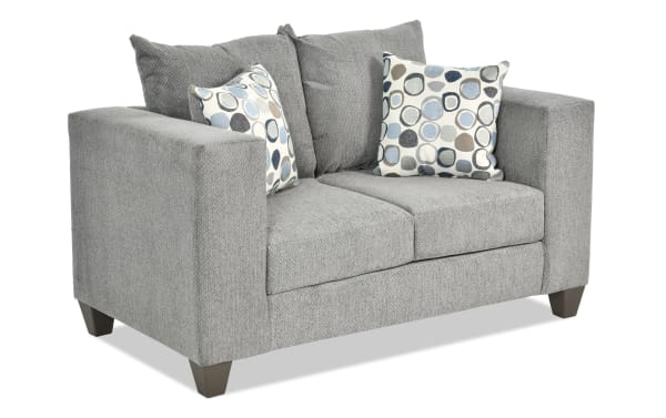 Emma Gray 62'' Loveseat with gray polyester fabric upholstery, transitional style, track arms, tapered legs, and two patterned accent pillows.