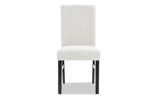 Contemporary Luna Dining chair with gray polyester fabric upholstery, solid back, and sturdy black MDF legs for comfortable dining seating.