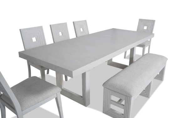 Contemporary Infinity 7 Piece White Upholstered Dining Set with MDF, rubberwood, oak veneers, and polyester fabric. Features extendable table, Bob-O-Pedic stuffed panel back chairs, and a white storage bench.