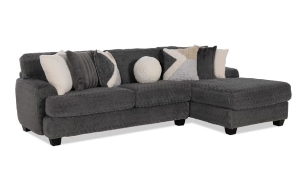 Doodle Gray 114" transitional 2-piece right arm facing sleeper chaise sectional in gray polyester fabric with accent pillows and full cooling mattress.