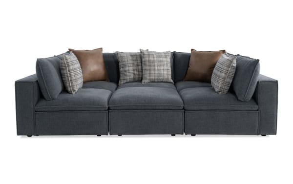 Infinity Thunder Blue 117'' 6-piece modular sectional in transitional style, blue polyester fabric, includes 3 armless chairs, 2 corners, 1 ottoman, with feather blend accent pillows and removable cushions.