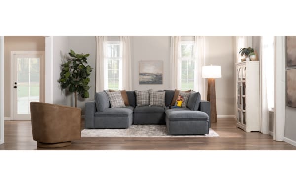 Transitional Infinity Thunder Blue 150" 6-piece modular sectional with 2 armless chairs, 2 corners, 2 ottomans in blue polyester fabric, featuring Bob-O-Pedic® seats, feather-blend pillows, removable cushions, and sturdy Siberian pine frame.