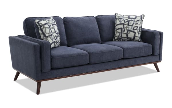 Tribeca Navy 90'' Sofa in mid-century modern style with navy polyester fabric, tapered wooden legs, memory foam cushions, and patterned accent pillows.
