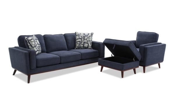 Tribeca Navy 90'' Sofa, Chair & Storage Ottoman set in mid-century modern style with blue polyester fabric, memory foam cushions, accent pillows, and hidden storage ottoman.