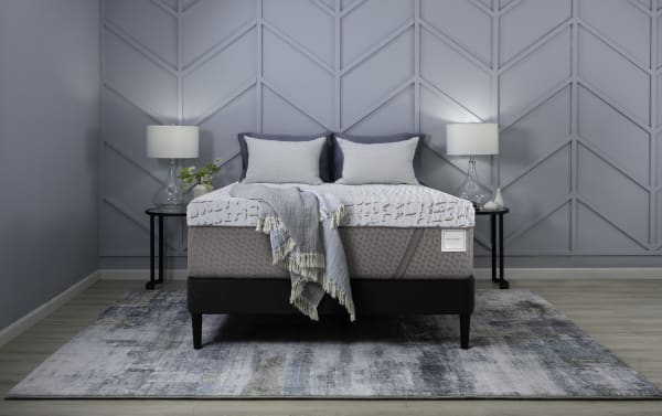 Enchant 16'' Twin XL Ultra Plush Standard Mattress Set in gray with cooling cover, plush foam, and black platform frame, styled in a modern blue bedroom.