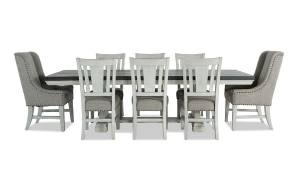Beaumont 9-piece beige transitional dining set with extendable pine wood table, fabric-upholstered memory foam chairs, and nailhead trim.