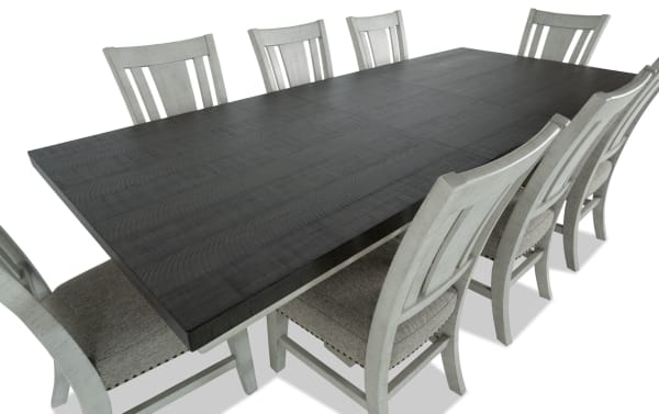 Beaumont 9 Piece Transitional Dining Set with beige polyester upholstered memory foam chairs and extendable dark brown pine veneer table with felt-lined storage drawers.