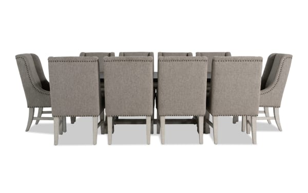 Beaumont 11-piece beige transitional dining set with extendable pine table and 10 beige polyester fabric upholstered chairs featuring nailhead trim.