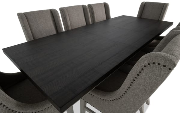 Beaumont 9-piece beige transitional dining set with extendable dark wood table and beige polyester fabric chairs featuring nailhead trim and memory foam seats.