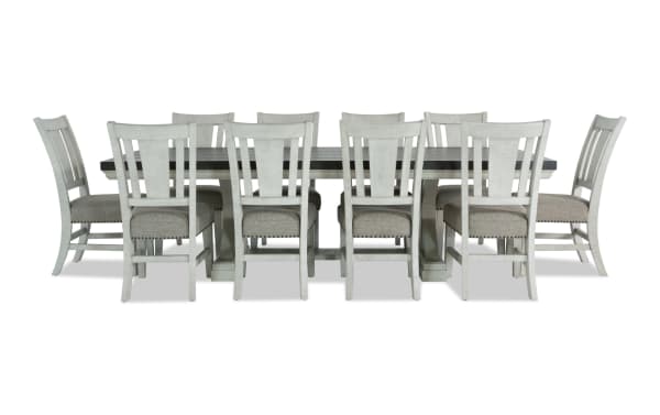Beaumont 11-piece beige transitional dining set with extendable pine wood table and upholstered polyester fabric chairs featuring memory foam seats and nailhead trim.