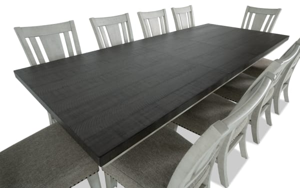 Beaumont 11-piece beige transitional dining set with extendable pine wood table and upholstered polyester fabric chairs featuring memory foam seats and nailhead trim.