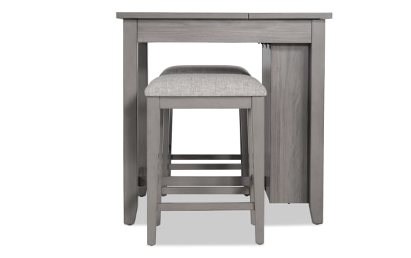Homeworks 3 Piece Gray Upholstered Counter Height Kitchen Island Set with cushioned stool, transitional style, melamine and rubberwood frame, lift-top storage.