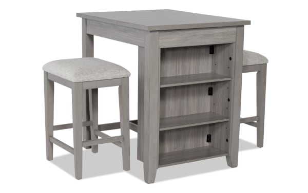 Homeworks 3 Piece Gray Upholstered Counter Height Kitchen Island Set with adjustable shelves, lift-top storage, and cushioned polyester stools in transitional style.