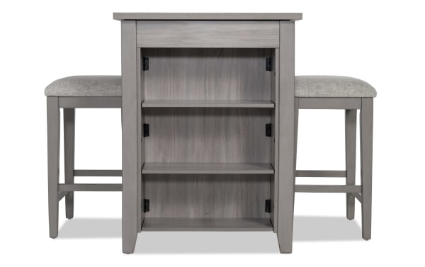 Homeworks 3 Piece Gray Upholstered Counter Height Kitchen Island Set with adjustable shelves, lift-top storage, and cushioned gray polyester stools in transitional style.