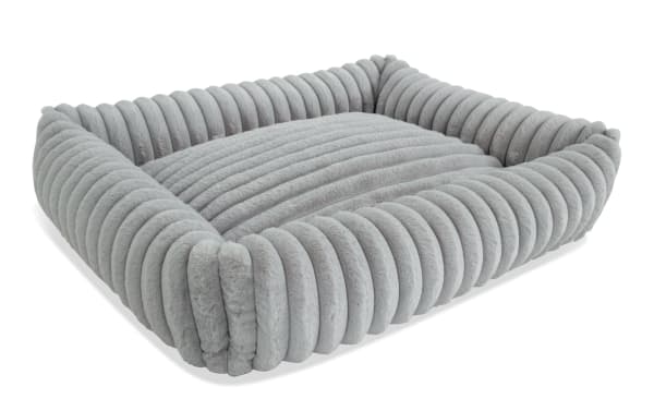Contemporary Sofia Gray Pup-O-Pedic Medium Pet Bed with plush gray polyester fabric, channel tufted cushion, and memory foam for pet comfort.