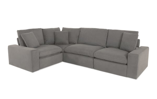 Dream Gray 131'' Power Reclining 4 Piece Modular Sectional in gray polyester fabric, transitional style with power headrests, 2 recliners, armless chair, and corner piece. Features oversized reversible cushions with jersey knit-like fabric and feather blend topper for customizable living room seating.