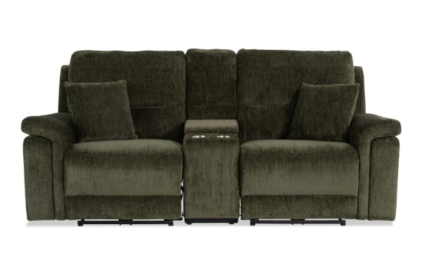 Renegade Green 88'' power reclining console loveseat in green polyester fabric with plush pillows, padded arms, USB ports, cupholders, and hidden storage.