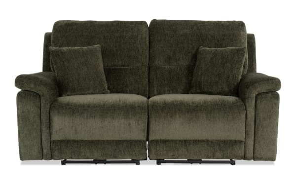 Renegade Green 75'' power reclining loveseat in plush green polyester fabric with padded pillow top arms, plush accent pillows, and built-in USB ports.