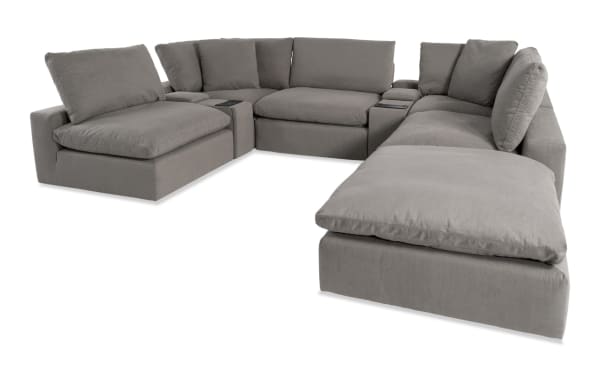 Dream Gray 144'' 8-piece modular sectional sofa in gray polyester fabric with 3 armless chairs, 2 consoles, 1 corner, 1 ottoman. Transitional style with oversized reversible cushions, feather blend topper, and built-in USB/USB-C ports for modern living room customization.