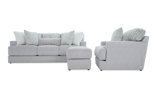 Contemporary Sofia Gray 93'' sofa, chair, and ottoman set in gray polyester fabric with channel tufted seat backs and plush accent pillows.