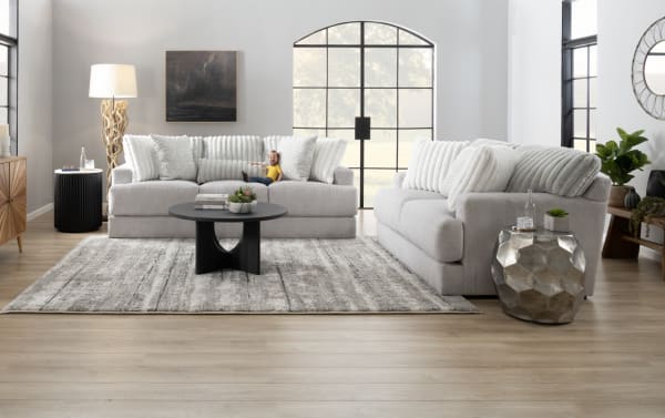 Contemporary Sofia Gray 93'' sofa and loveseat set in gray polyester fabric with channel tufted seat backs and plush accent pillows.