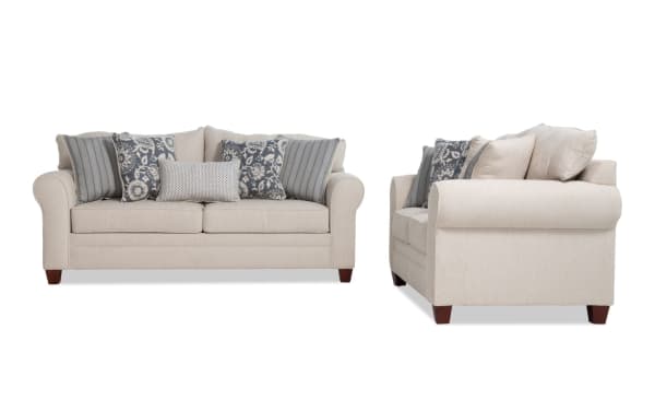 Portland Beige 85'' Sofa and 65'' Loveseat set in transitional style, beige polyester fabric upholstery with rolled arms and patterned accent pillows.