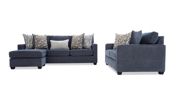 Modern sectional sofa with dark blue fabric upholstery, featuring a chaise lounge on the left side, patterned accent pillows, and a sleek, contemporary design.