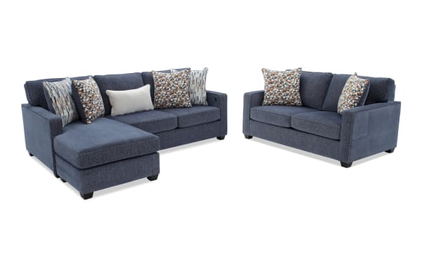 Modern navy blue fabric sectional sofa set with chaise lounge and matching loveseat, featuring patterned and solid throw pillows for living room seating.