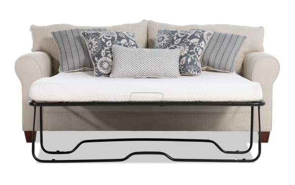 Beige Portland 85'' transitional sleeper sofa with soft polyester fabric, accent pillows, and queen gel memory foam mattress for comfort and style.