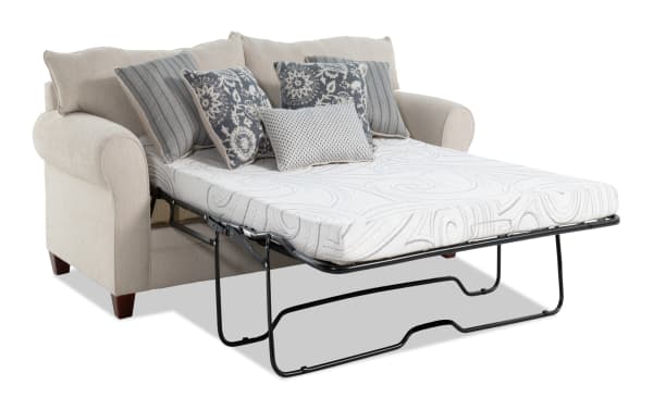 Beige Portland 85'' transitional sleeper sofa with soft polyester fabric, accent pillows, and queen-size cooling gel memory foam mattress extended for sleeping.