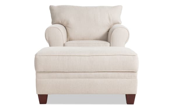 Beige Portland transitional chair and storage ottoman set with soft polyester fabric upholstery, rolled arms, accent pillow, and wooden legs.