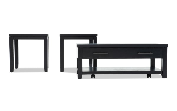 Set of three black wooden tables including a rectangular coffee table with drawer and two square side tables, featuring modern minimalist design and metal handles.