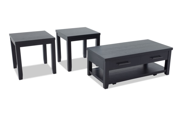 Set of three black wooden tables including two square end tables and one rectangular coffee table with drawers and lower shelf, modern style.