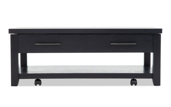Modern black wooden coffee table with a rectangular top, two metal handles, an open lower shelf, and caster wheels for mobility.
