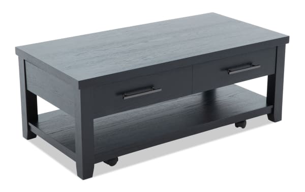 Modern black wooden coffee table with two drawers, metal handles, and a lower shelf on caster wheels for storage and mobility.
