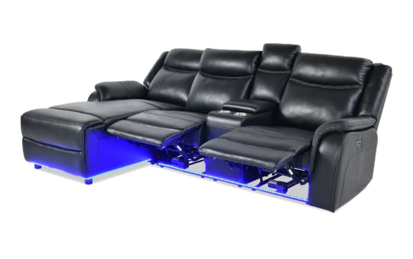 Prism Black 100'' Immersive Audio power reclining sectional in black faux leather with LED lighting, Bluetooth speakers, USB ports, and memory foam.