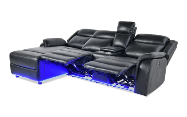 Prism Black 100'' Immersive Audio Power Reclining 2-Piece Left Arm Facing Sectional in black faux leather with Bluetooth speakers, LED lighting, and USB ports.