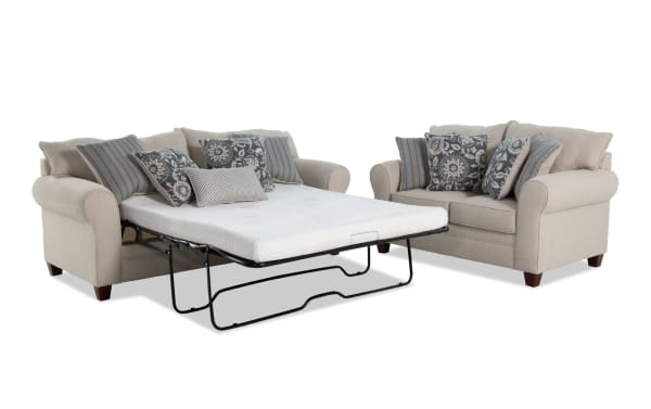 Beige Portland transitional 85" sleeper sofa with queen gel memory foam mattress and 65" loveseat, polyester fabric upholstery, and patterned accent pillows.
