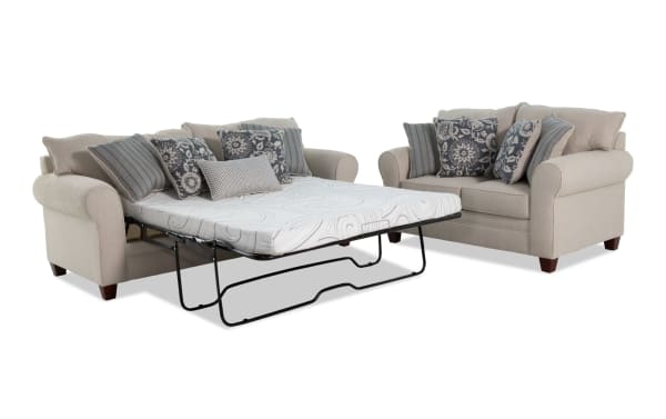 Beige Portland transitional 85" sleeper sofa with queen cooling gel memory foam mattress and 65" loveseat, polyester fabric upholstery, and decorative pillows.