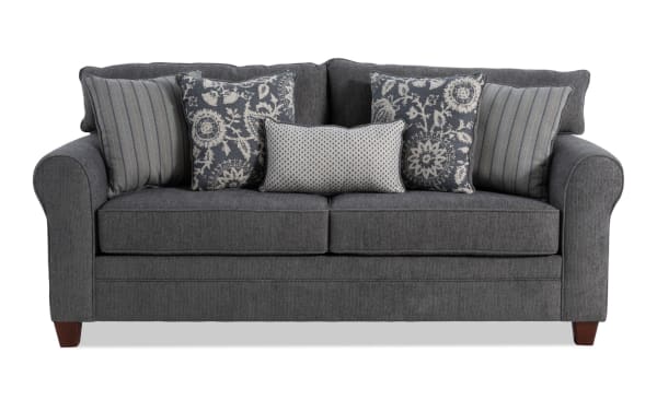 Transitional Portland Gray 85'' sofa with rolled arms, gray polyester fabric upholstery, and five decorative accent pillows for living room comfort.